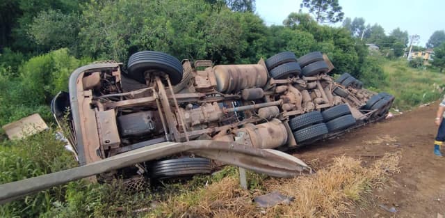 Caminhoneiro é retirado pelo para-brisa em tombamento 